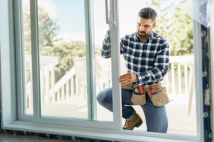 expert installing window in a new house construction site