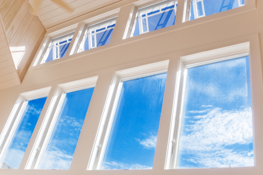 Huge wall of windows with a blue summer sky